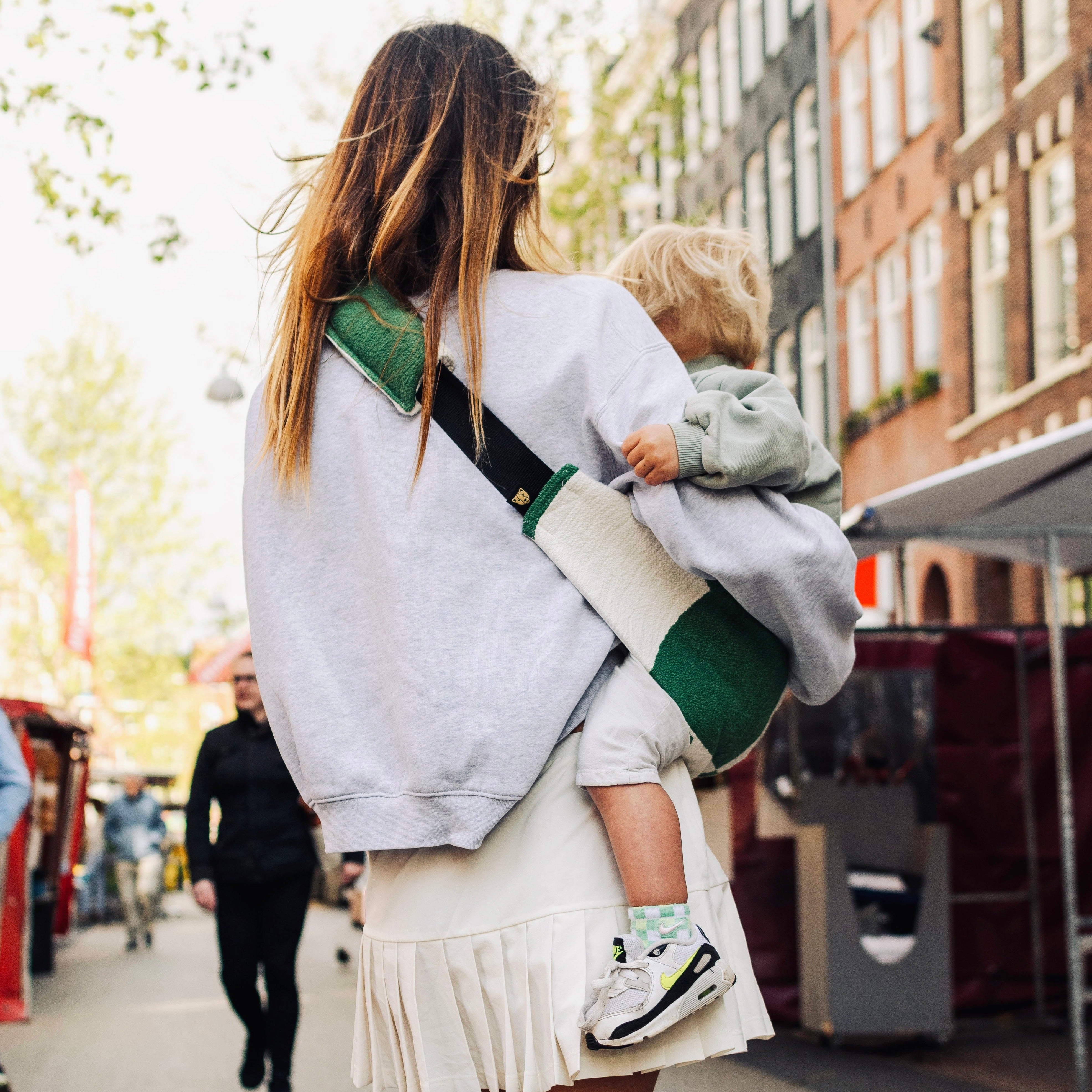 green graphic toddler carrier for moms