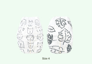 Two pairs of white socks with different patterns on a light green background