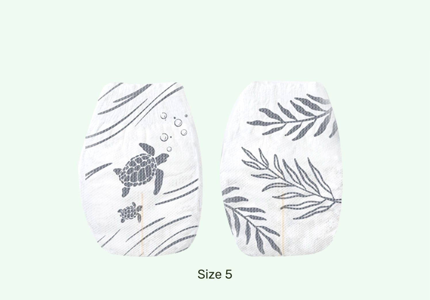 Pair of white socks with turtle and leaf patterns on a light green background